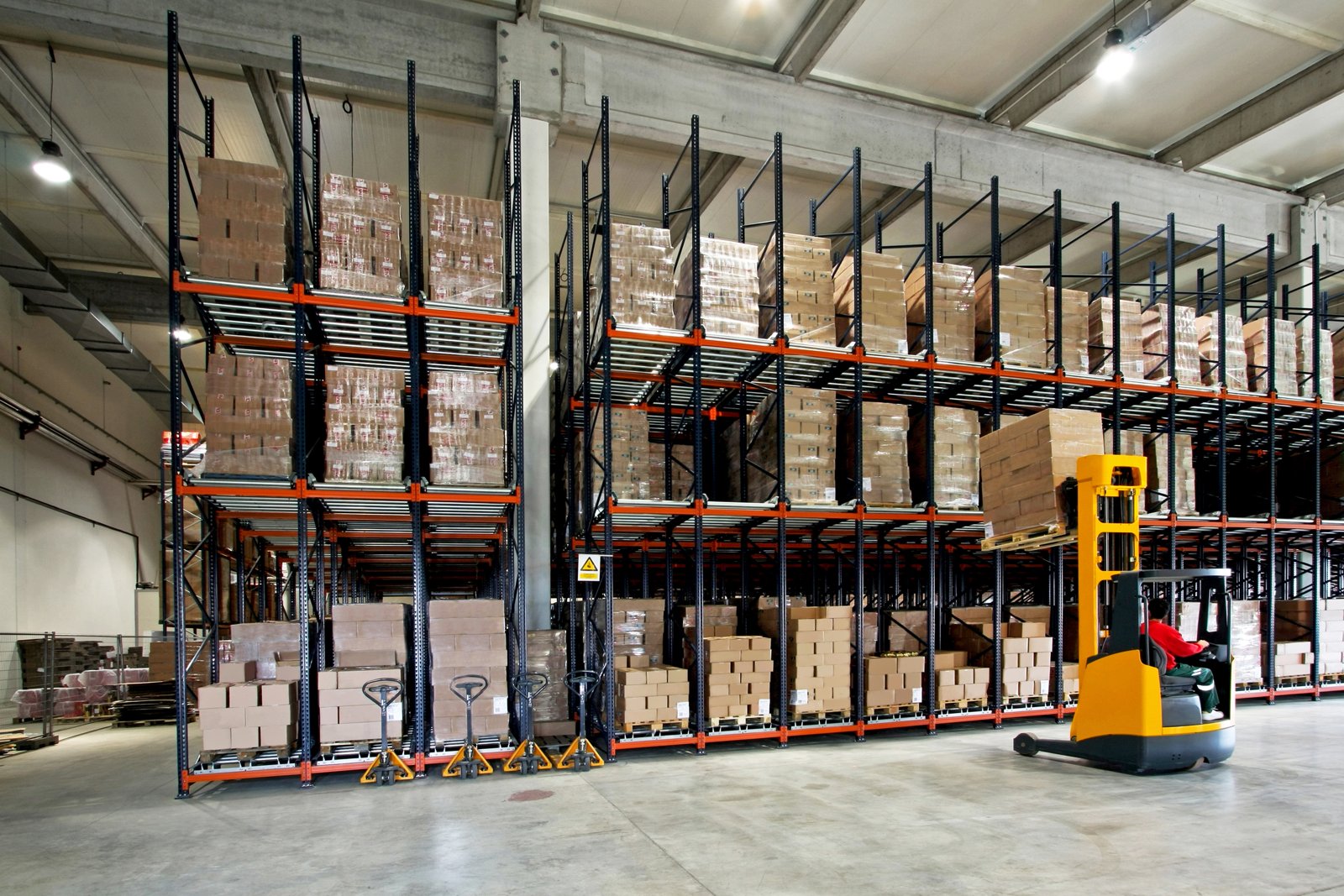 Reach truck lifting a pallet in a builders merchant warehouse
