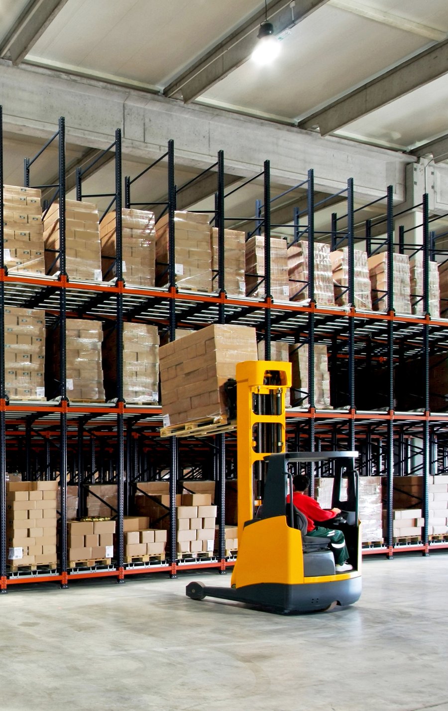 Reach truck in a builders merchant warehouse aisle